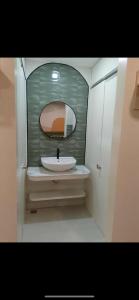 a bathroom with a sink and a mirror at Pension Bacolod in Bacolod