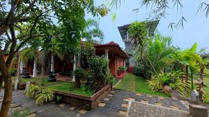 a house with a garden in front of it at Meegahapokuna Resort in Anuradhapura
