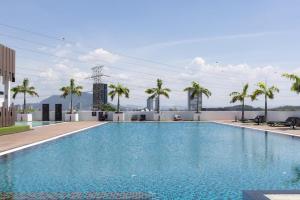 a swimming pool on top of a building with palm trees at Meritus Suites - 8pax in Perai