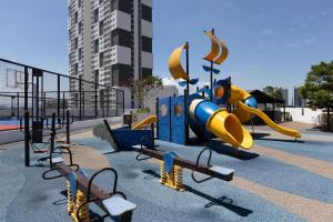 a playground with a slide in a park at Meritus Suites - 8pax in Perai