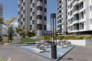a park in a city with tall buildings at Meritus Suites - 8pax in Perai
