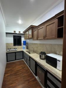 a kitchen with a sink and a microwave at Villa Sulthon in Tawangmangu