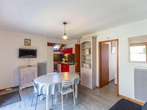 a kitchen and dining room with a table and chairs at Chalet terrasse - 5 pers. Cauterets calme - FR-1-401-322 in Cauterets