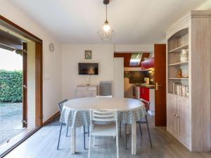 a kitchen and dining room with a table and chairs at Chalet terrasse - 5 pers. Cauterets calme - FR-1-401-322 in Cauterets +8 photos