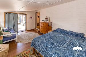 a bedroom with a bed and a dresser in it at Dune Cottage Stay 3 Pay 2 Winter Special in Sandy Point