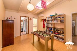 a room with a game table in the middle of it at Dune Cottage Stay 3 Pay 2 Winter Special in Sandy Point