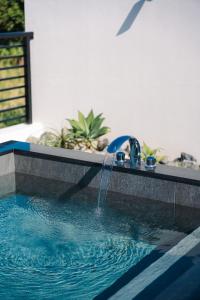 a swimming pool with a water fountain at Luxury Villa Maeda Unit2 in Onna