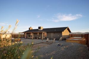 a house in the middle of a field at Dark Star - Endless Stars, Cowboy Pool, Spa, Fire pit, BBQ in Twentynine Palms