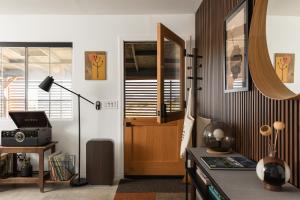 a living room with a door and a desk at Dark Star - Endless Stars, Cowboy Pool, Spa, Fire pit, BBQ in Twentynine Palms