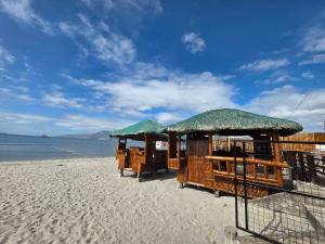 a beach with two huts on the beach at Baywatch Beach Resort in Olongapo