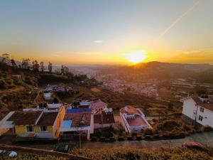 an aerial view of a city at sunset at Ooty Peak view villa in Ooty