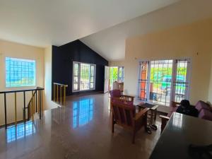 an empty living room with a person sitting at a desk at Ooty Peak view villa in Ooty