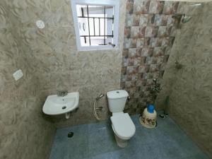 a bathroom with a toilet and a sink at Ooty Peak view villa in Ooty +56 photos