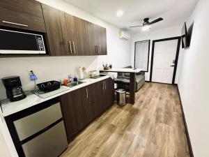 a kitchen with wooden cabinets and a table in it at Apartaments in Sandy Bay in Sandy Bay