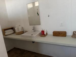 a bathroom counter with a sink and a mirror at Corazón zen in Barra de Potosi