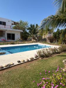 a swimming pool in front of a house at Corazón zen in Barra de Potosi