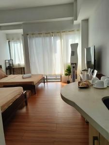 a large room with two beds and a table in it at Condotel in Baguio City in Baguio