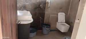 a small bathroom with a sink and a toilet at Om Niwas Bhunga in Bhuj
