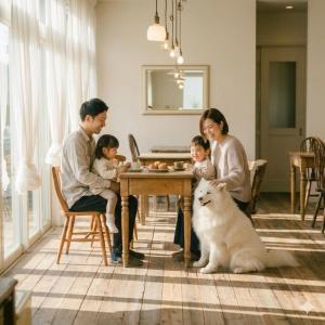 a family sitting at a table with a white dog at koyado kaziya in Ichinoseki