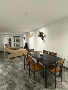 a living room with a table and chairs and a couch at Alma del Mar in Volcán Chimborazo
