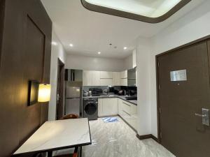 a small kitchen with a table and a door at Viewtiful Elegant 16th Floor 1BR Getaway 1Euphoria in Angeles