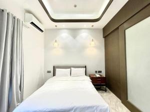 a bedroom with a white bed and a window at Viewtiful Elegant 16th Floor 1BR Getaway 1Euphoria in Angeles
