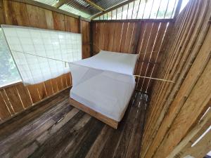 an inside view of a wooden shack with an umbrella at Hostal Posada Turística El Bejuco in Leticia