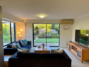 a living room with a couch and a tv at Wandju Villa in Geographe