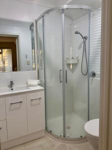 a bathroom with a shower and a sink and a toilet at Wandju Villa in Geographe +22 photos