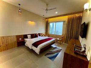a bedroom with a bed and a large window at Cedar wave in Munsyari +26 photos