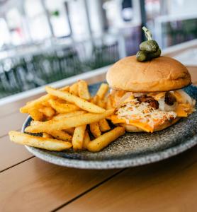 a plate of food with a sandwich and french fries at Tocumwal Hotel Motel in Tocumwal +5 photos