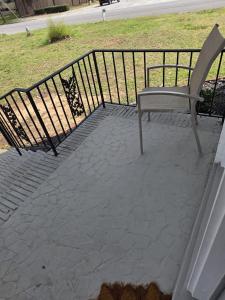 a bench sitting on a patio next to a fence at Private guest rooms & baths in Atlanta