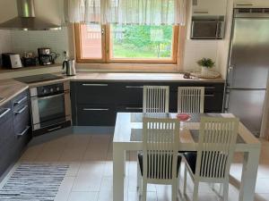 a kitchen with a table and chairs in a kitchen at Villa Maya, cottage for vacation holidays in Jaala