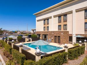 a hotel with a pool in front of a building at Hampton Inn by Hilton Spring Hill in Timber Pines