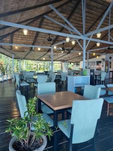 a dining room with a wooden table and chairs at Melina Beach Resort in Tioman Island