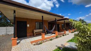 a house with hammocks outside of it at Rústicas Dani & Fam in Fortuna