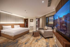 a hotel room with a bed and a flat screen tv at Quiet Dreams - Serviced Apartments King abdul Aziz Street Branch in Jeddah