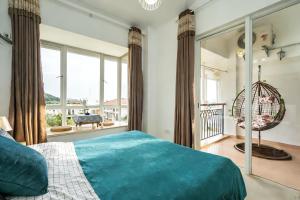 a bedroom with a large bed and a large window at Yalong Sea Joy in Sanya +68 photos