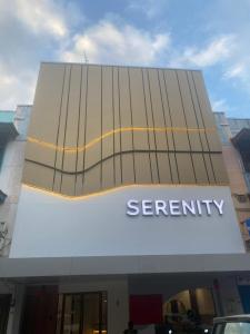 a building with a security sign on the side of it at Serenity Homestay Penuin Batam in Batam Center