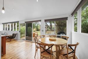 a kitchen and dining room with a table and chairs at The Bach at Ventnor in Ventnor