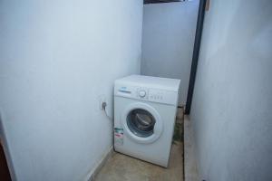 a washer and dryer in a corner of a building at Nasha Lanka House in Koggala