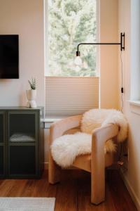 a furry chair sitting in front of a window at Camp Alpine in Packwood