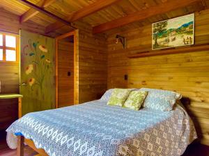 a bedroom with a bed in a wooden cabin at Cabañas ecológicas Xuetama in Villa de Leyva
