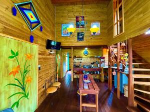 a dining room with a table in a wooden house at Cabañas ecológicas Xuetama in Villa de Leyva