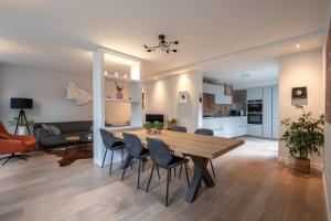 a dining room and living room with a table and chairs at Unique tranquil spot with garden, centre Den Bosch in Den Bosch