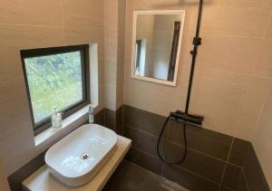 a bathroom with a sink and a window at Brotherhood Loop Hostel Station in Làng Lap