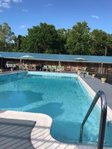 a large swimming pool in front of a building at Merrimac Inn and Suite in Williamsburg