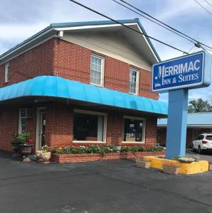 a restaurant with a sign in front of a building at Merrimac Inn and Suite in Williamsburg