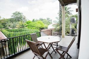 a patio with a table and chairs on a balcony at Walker's Residency in Anuradhapura