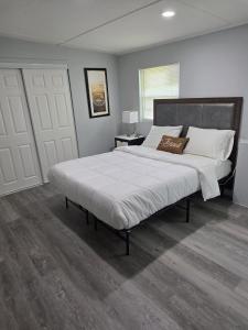 a bedroom with a large bed with white sheets and pillows at Private guest rooms & baths in Atlanta